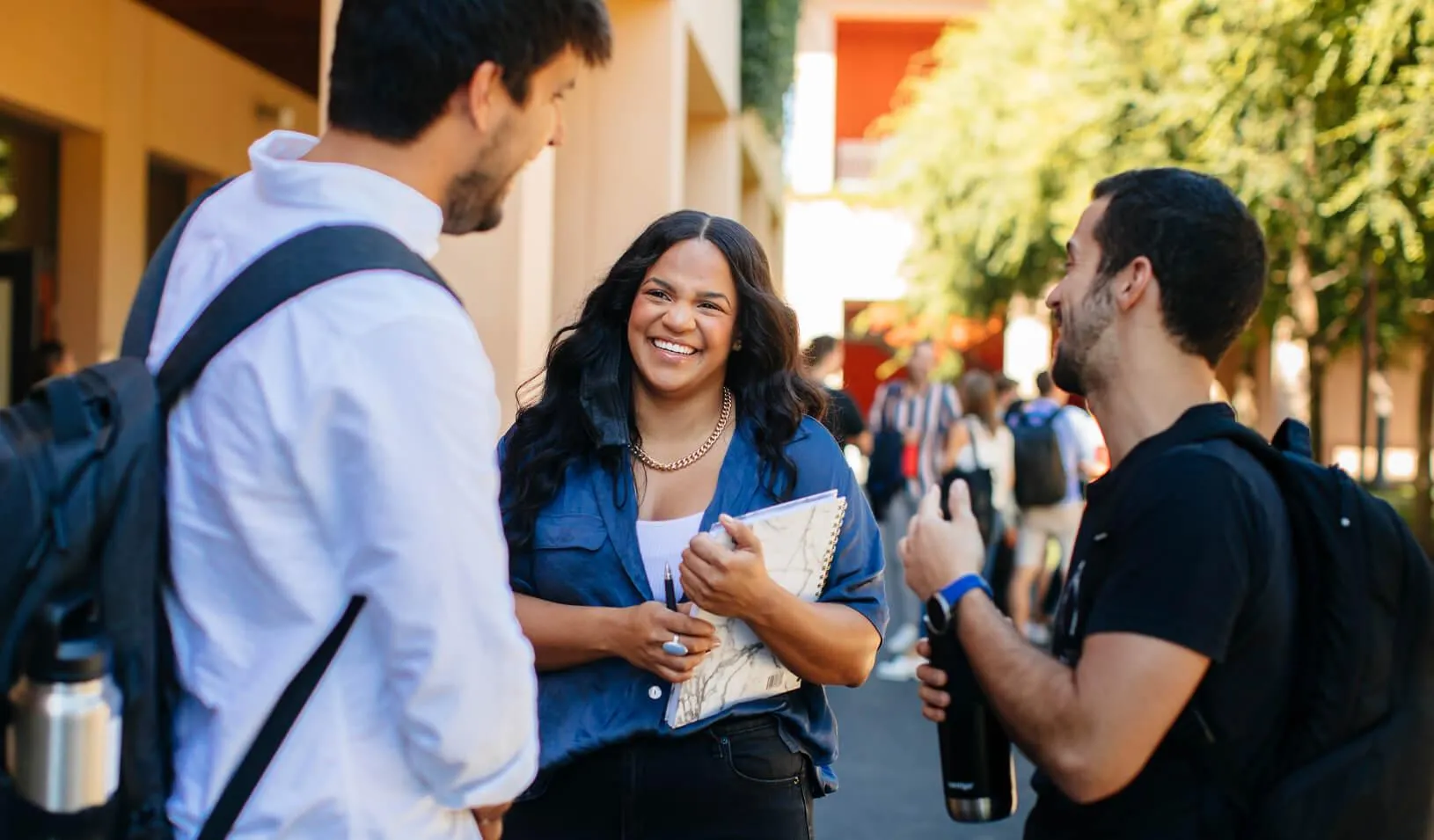 3 students standing and talking
