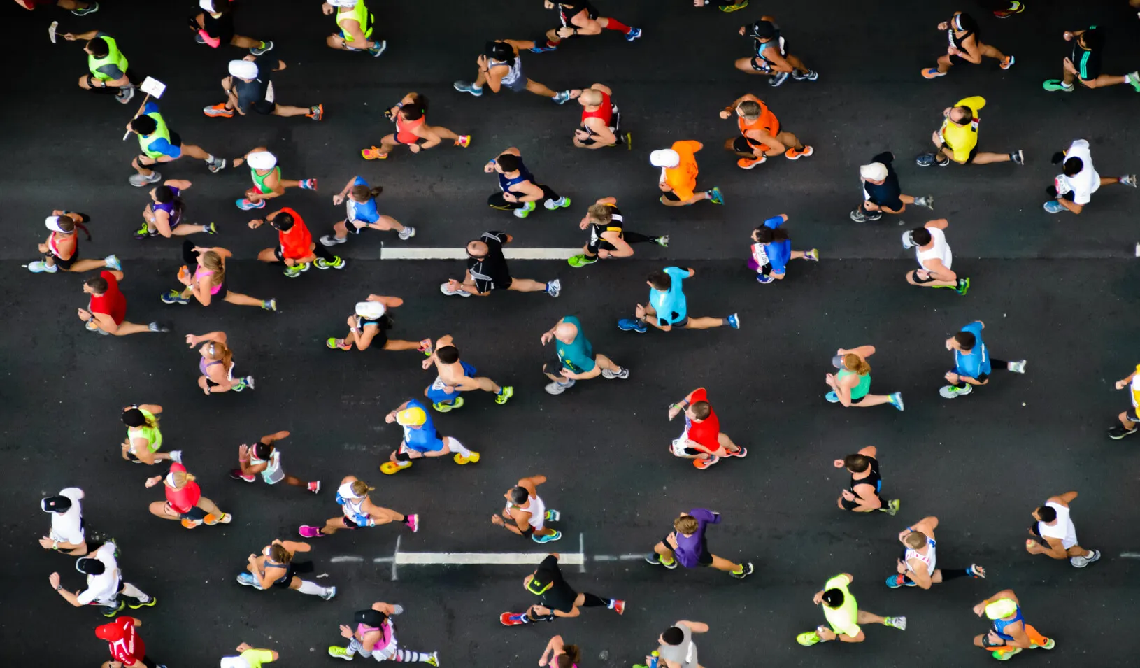 An overhead photo of runners competing in a marathon. Credit: iStock/ZamoraA