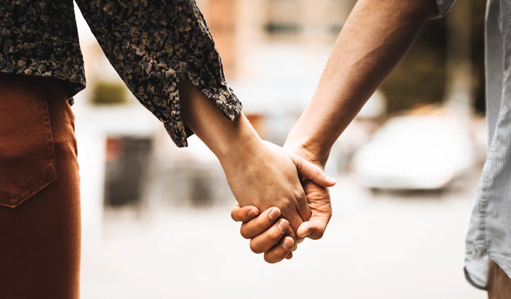 A close up photo of a couple holding hands. Credit: iStock/franckreporter