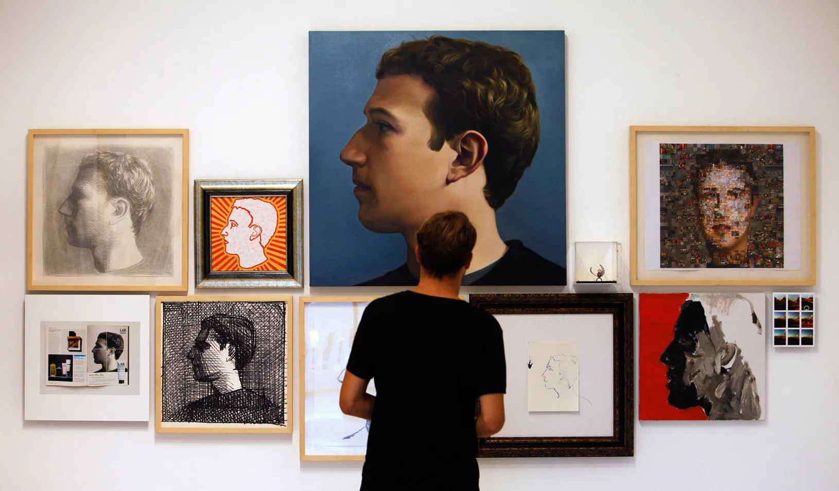 Portraits of Mark Zuckerberg hanging on a wall.