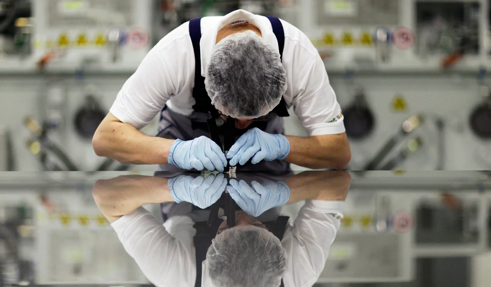 A worker checks a photovoltaic module in Germany. (Reuters photo by Hannibal Hanschke)