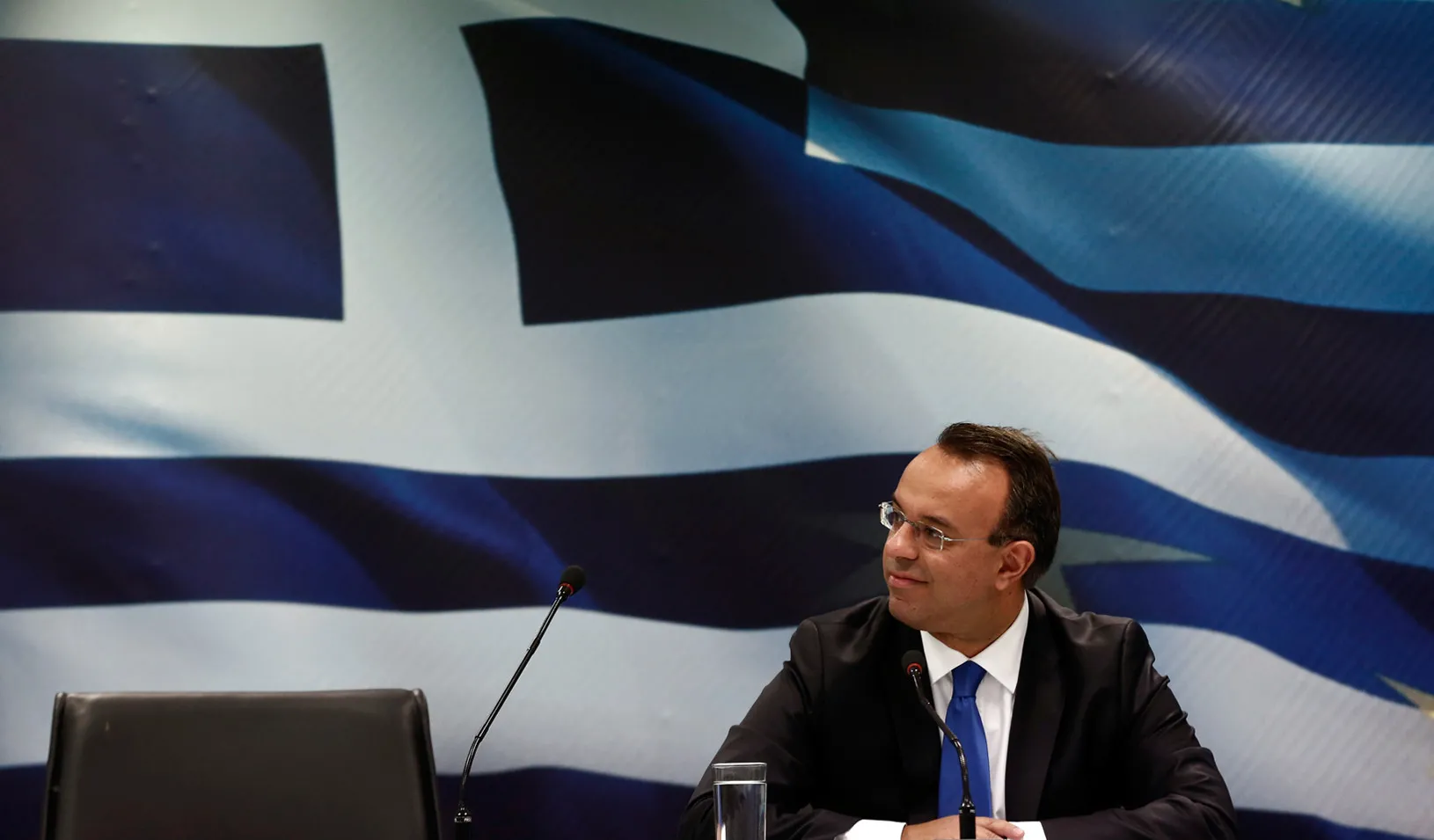 Greek Deputy Finance Minister Christos Staikouras smiles at reporters during a briefing at a ministry hall in Athens, 2013. (Reuters photo by Yorgos Karahalis )