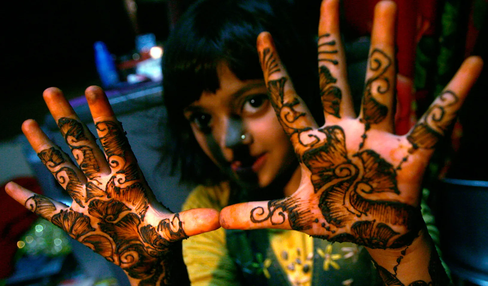 Rubina Ali, who acted as young Latika in the film "Slumdog Millionaire" shows mehndi painted on her hands in the slum she resides in. (Reuters photo by Arko Datta)