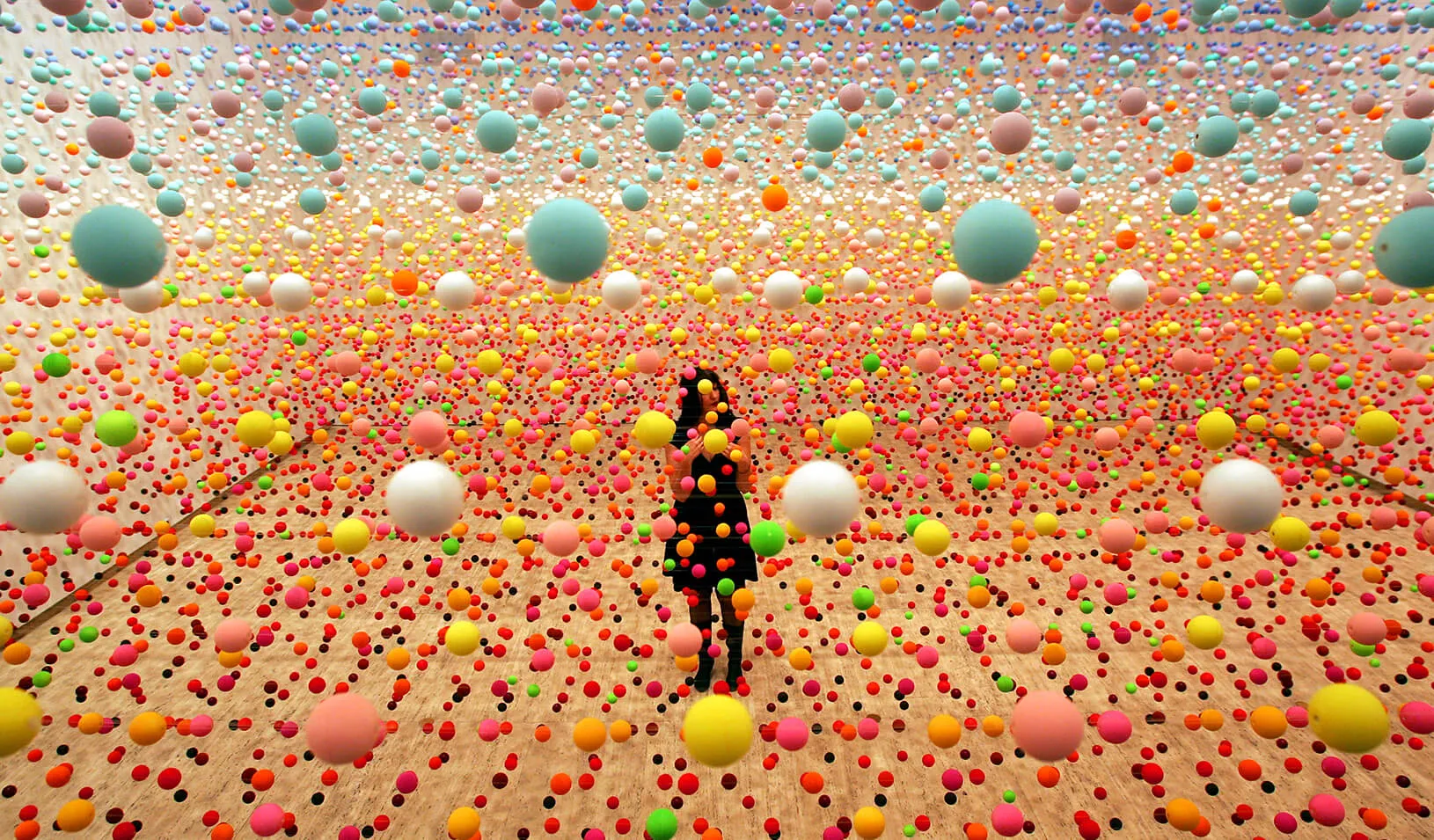 A woman stands in a field of dots |  Reuters/David Gray 