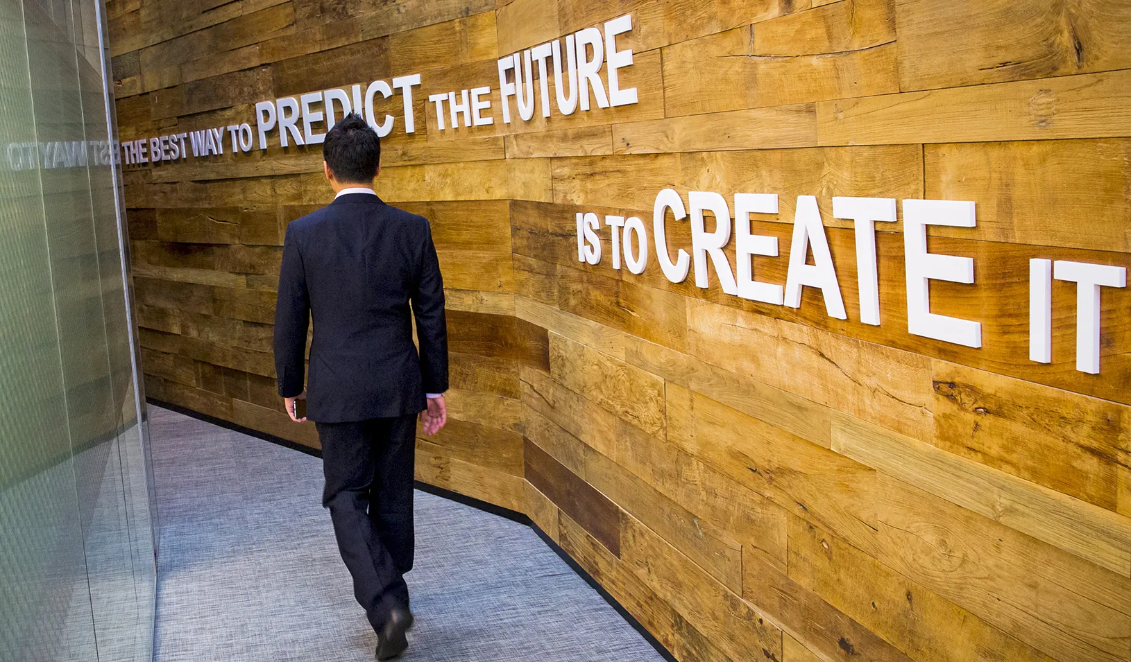 Man walking past a slogan at the Google Campus start-up space in the Gangnam district of Seoul | Reuters/Thomas Peter