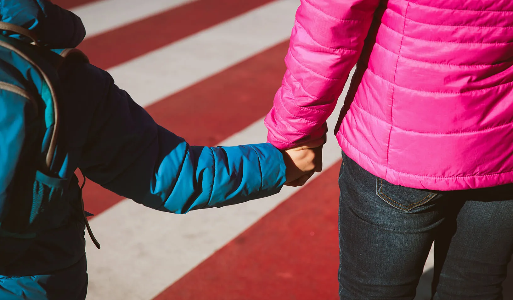 Mother holding hand of son | iStock/Nadezhda1906