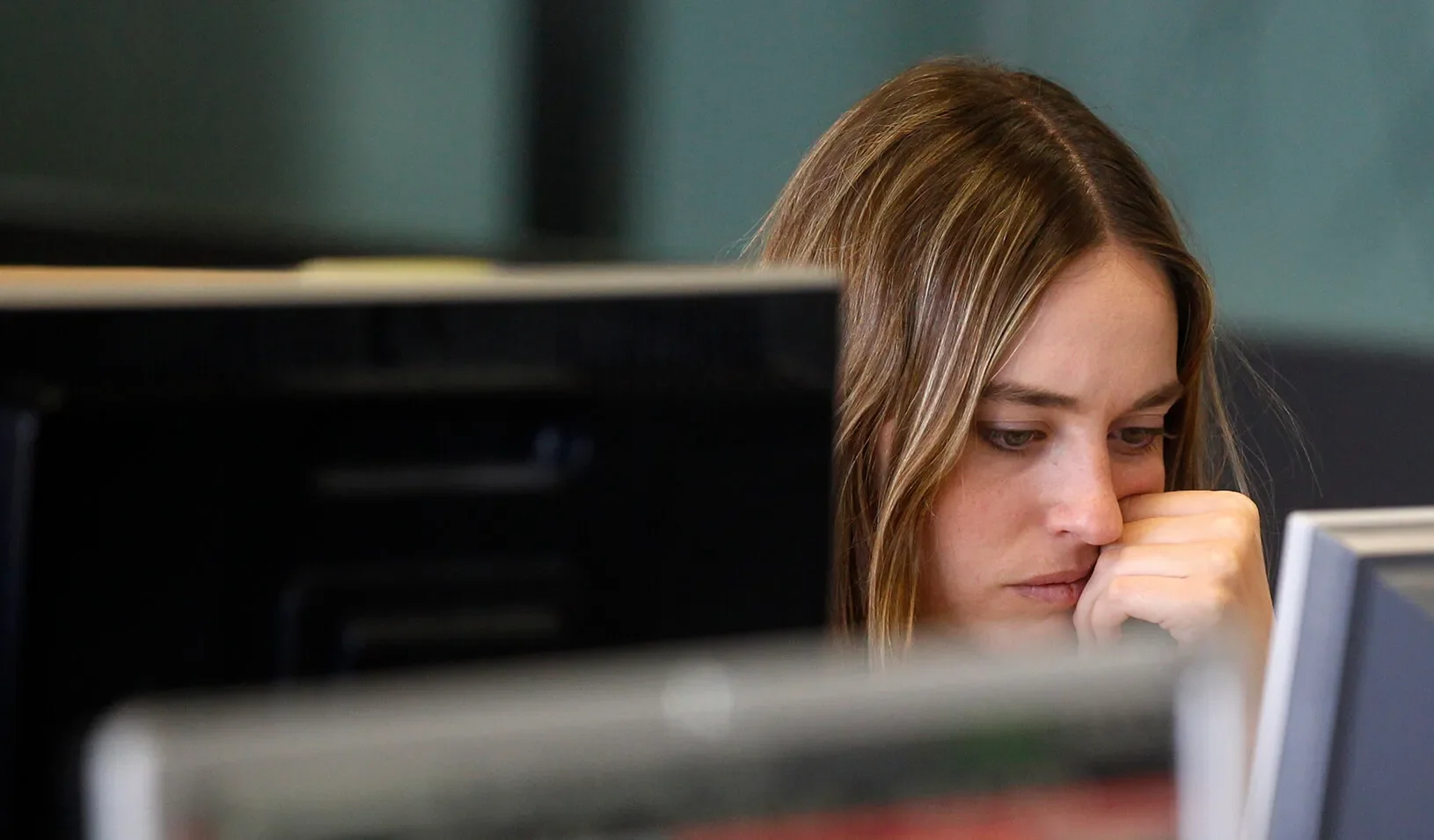 A woman looks at her computer screen. | Reuters/Andrea Coma