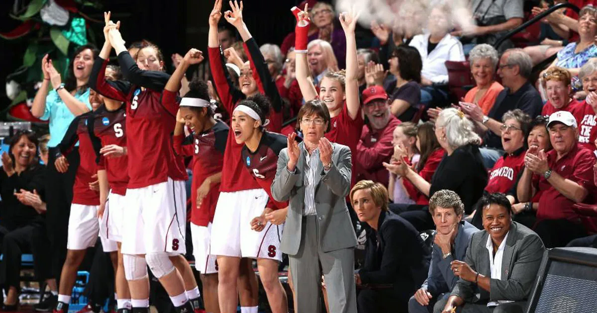 Stanford women's basketball team with cheering crowd behind them