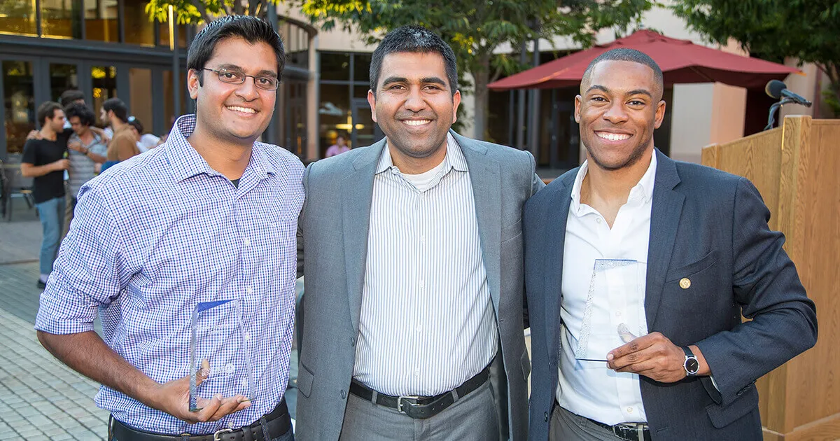2016 Social Innovation Fellows Rajan Patel (left) and Ronnie Washington (right) flank Neil Malhotra, faculty director of the Center for Social Innovation | Stacy Geiken Photography