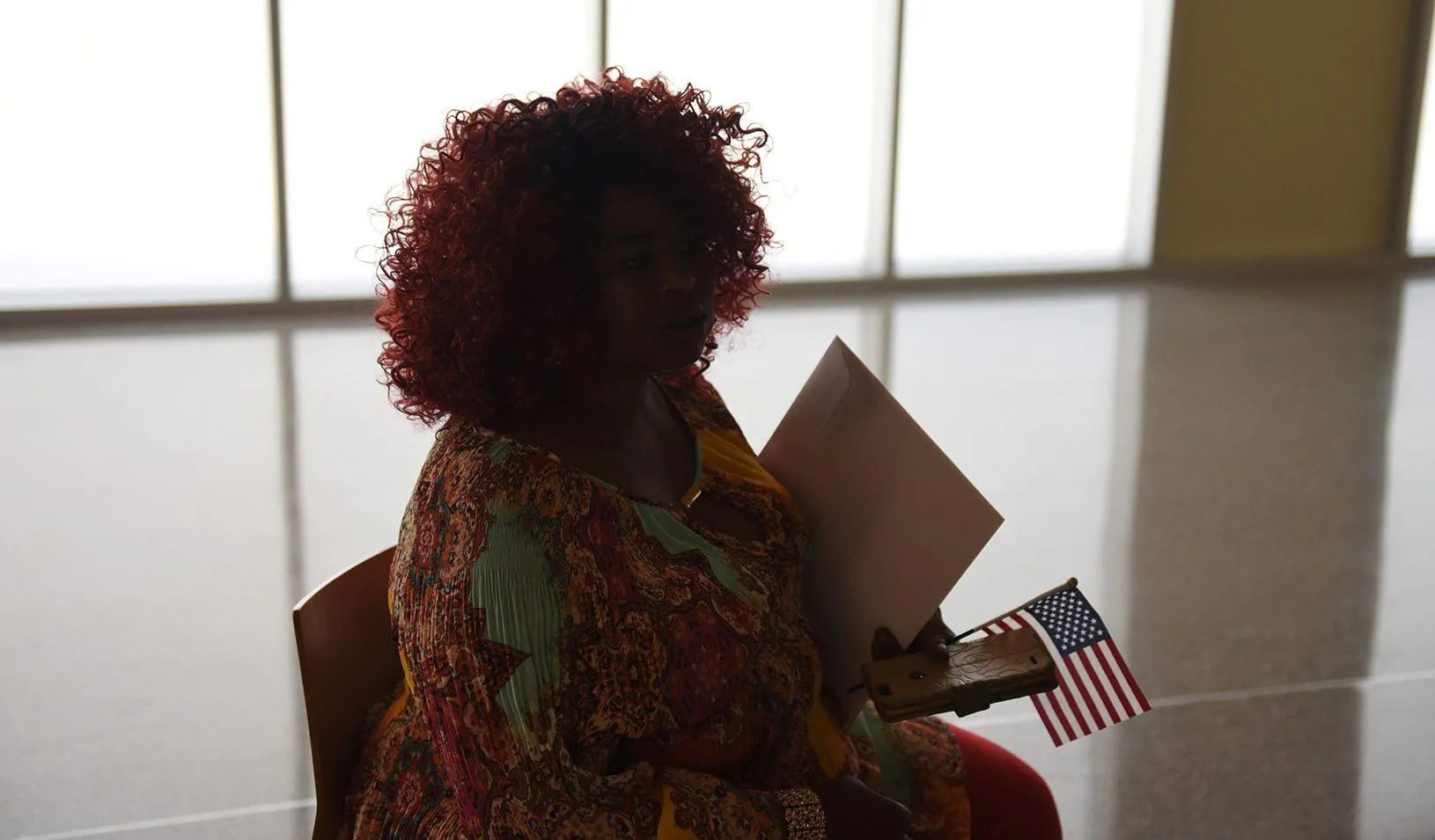 A woman holds an American flag after her daughter’s naturalization ceremony in San Antonio, Texas. Reuters/Callaghan O’Hare