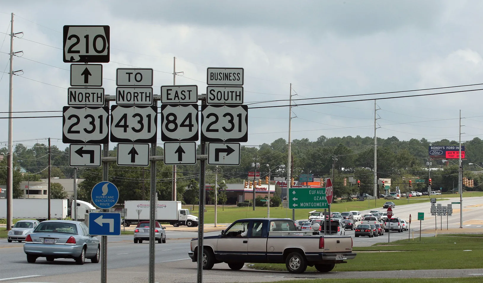 A bunch of highway road signs