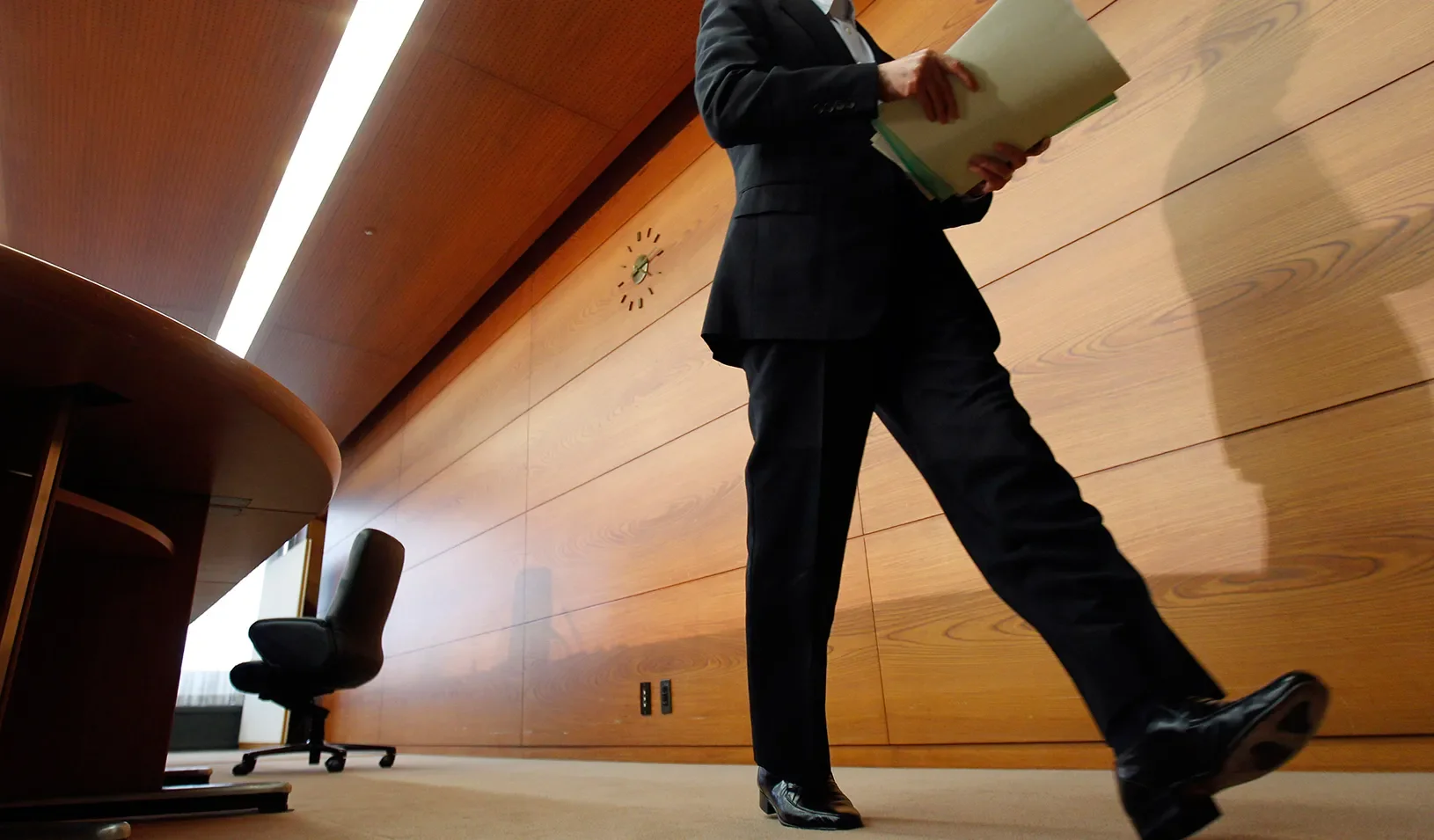 Business man walking in an office. | REUTERS/Kim Kyung-Hoon