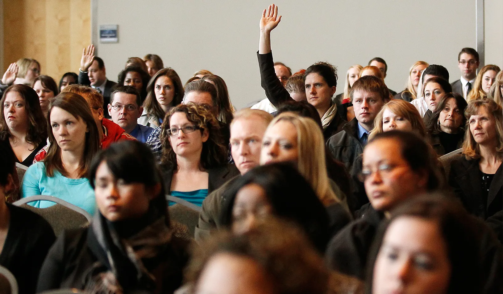 A job seeker raises his hand to ask a question | Reuters/Rick Wilking