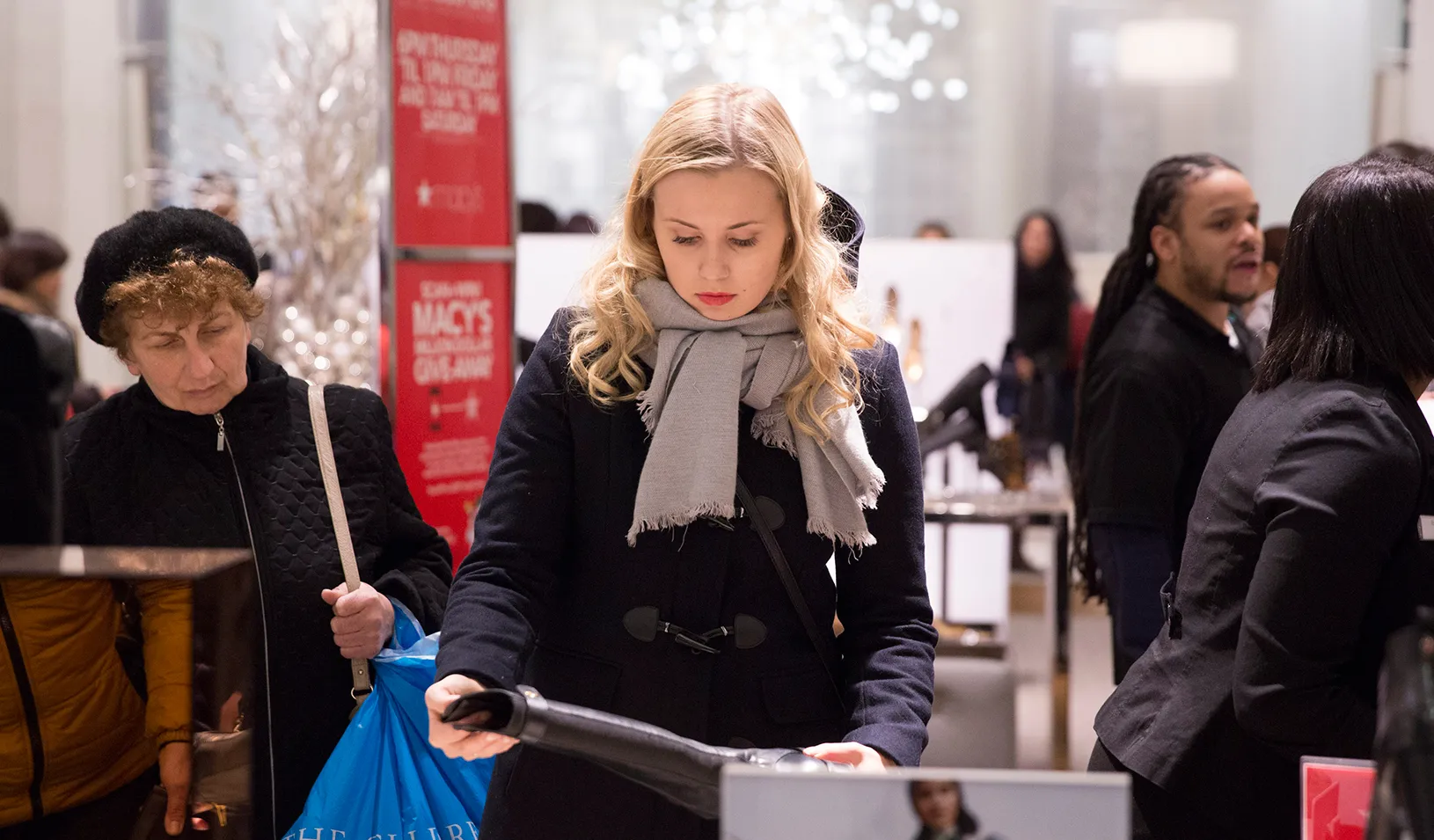 Woman shopping for winter boots. | Reuters/Andrew Kelly