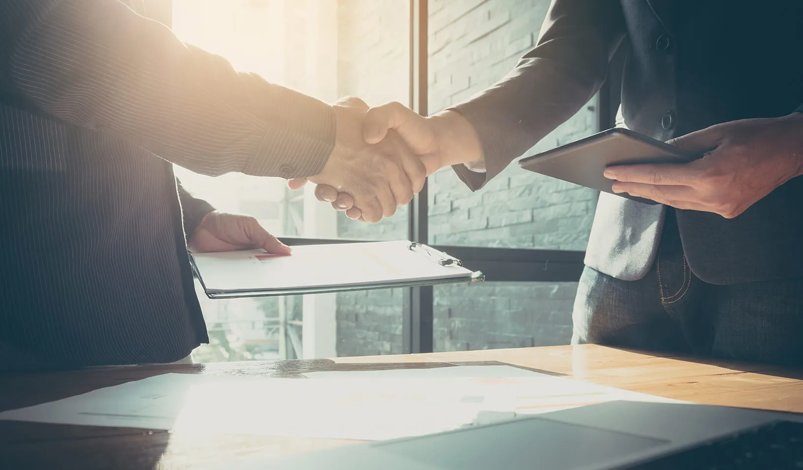 Shaking hands after a business meeting. | iStock/nateemee