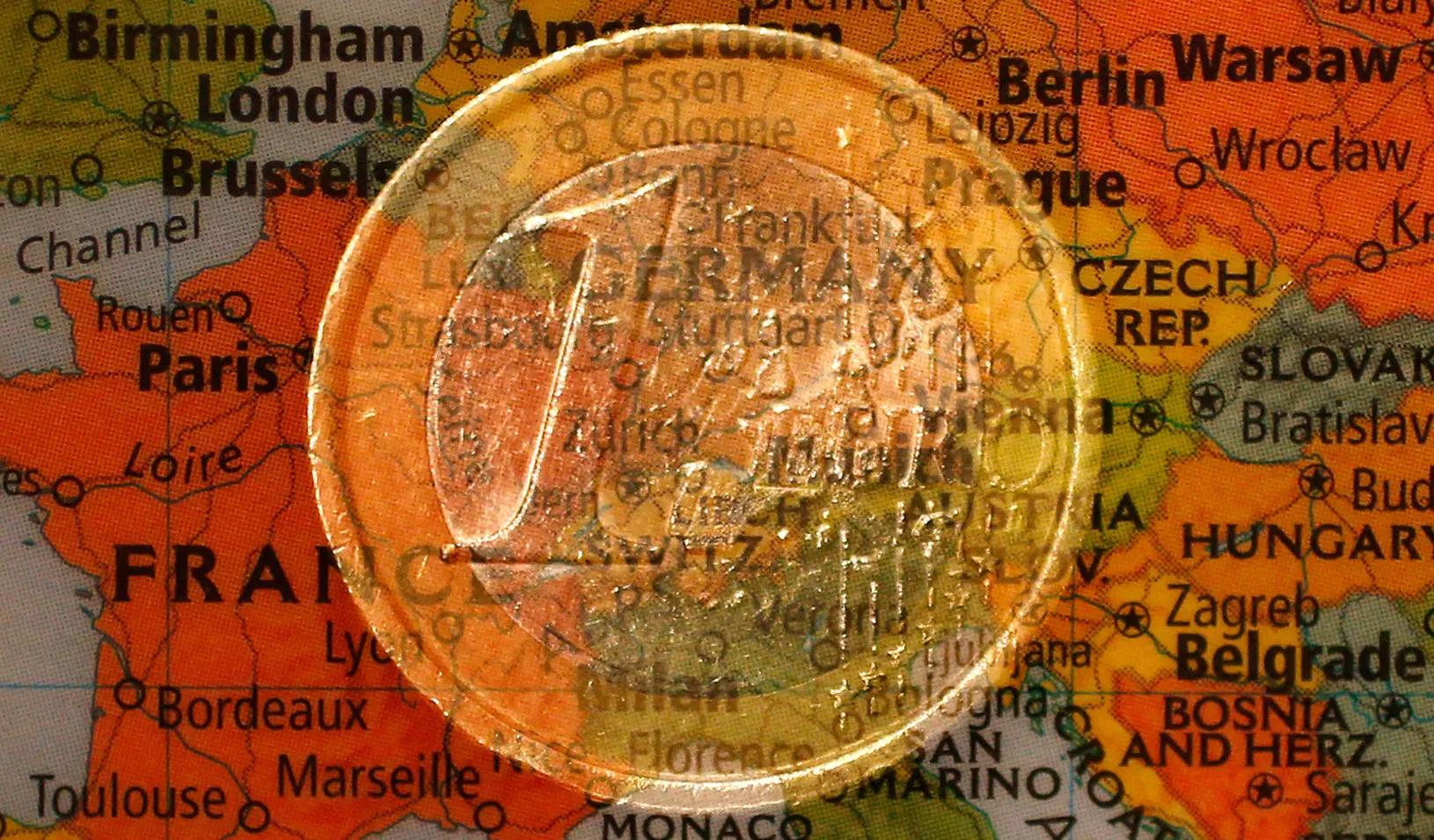 A euro coin and a map of Europe (Reuters photo by Kai Pfaffenbach)